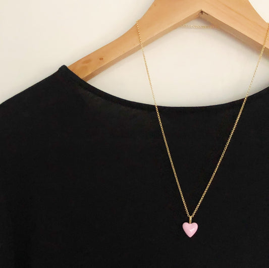 Pink heart necklace shown on