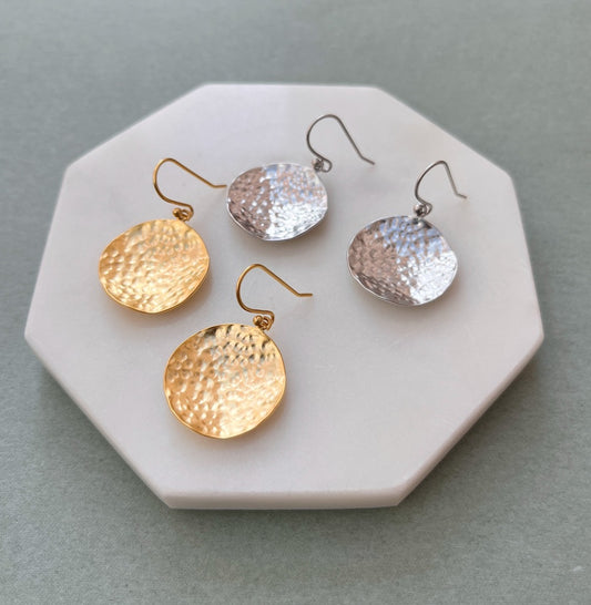 Hammered coin earrings in gold and silver flatlay