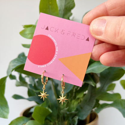 North star mini hoop earrings on our branded backing cards