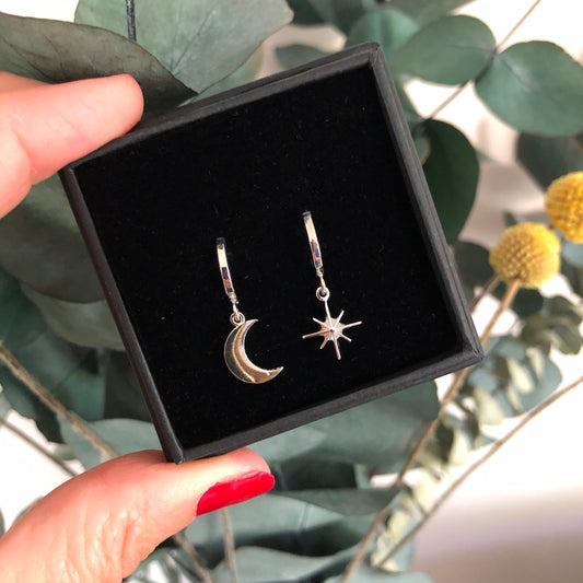 Silver moon and star mini hoop earrings shown in gift box